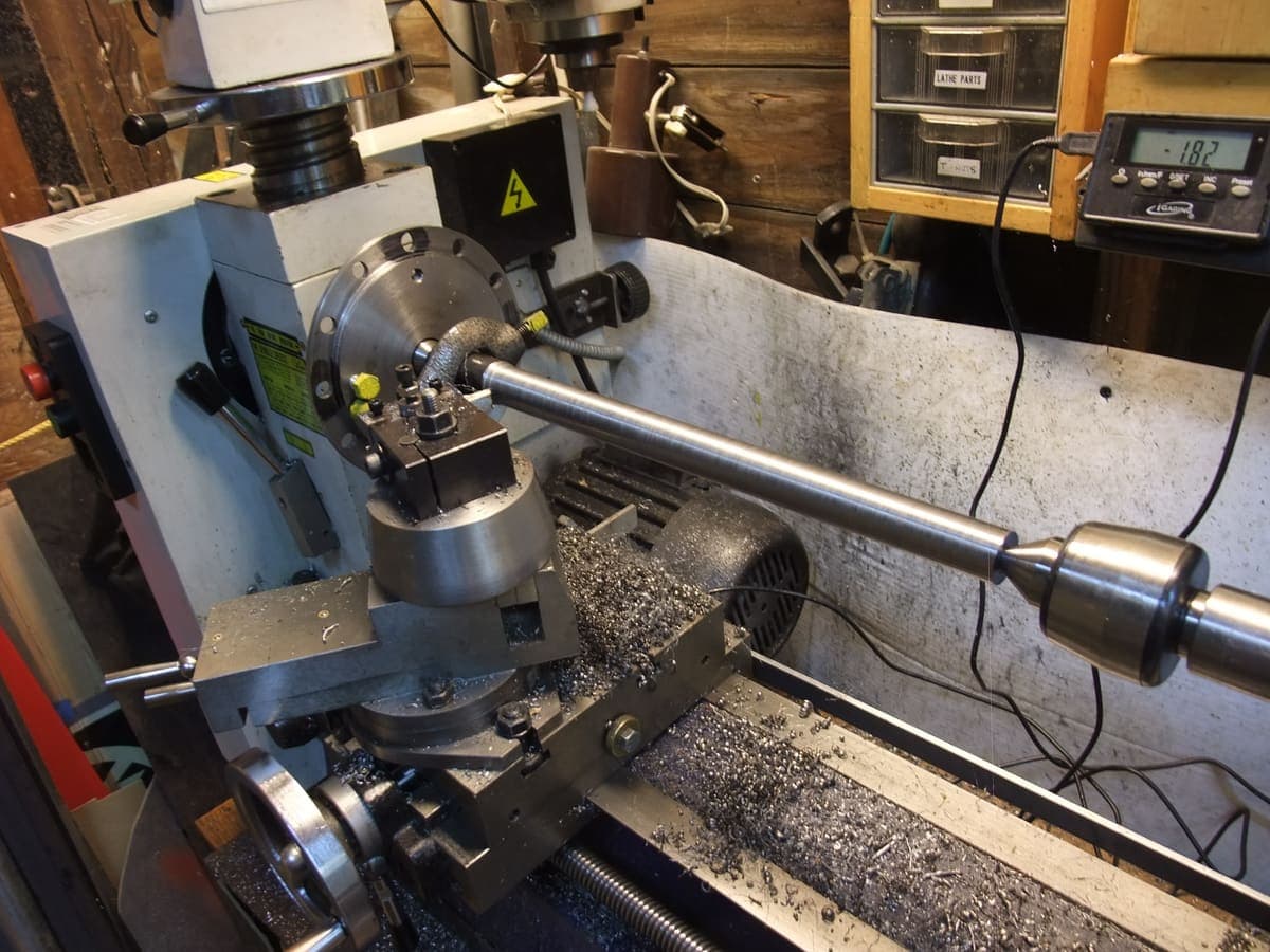 Turning a metal shaft on the lathe at Sri Dhanalakshmi Industries